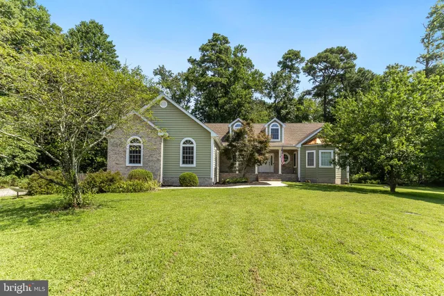 a view of a house with pool and a yard