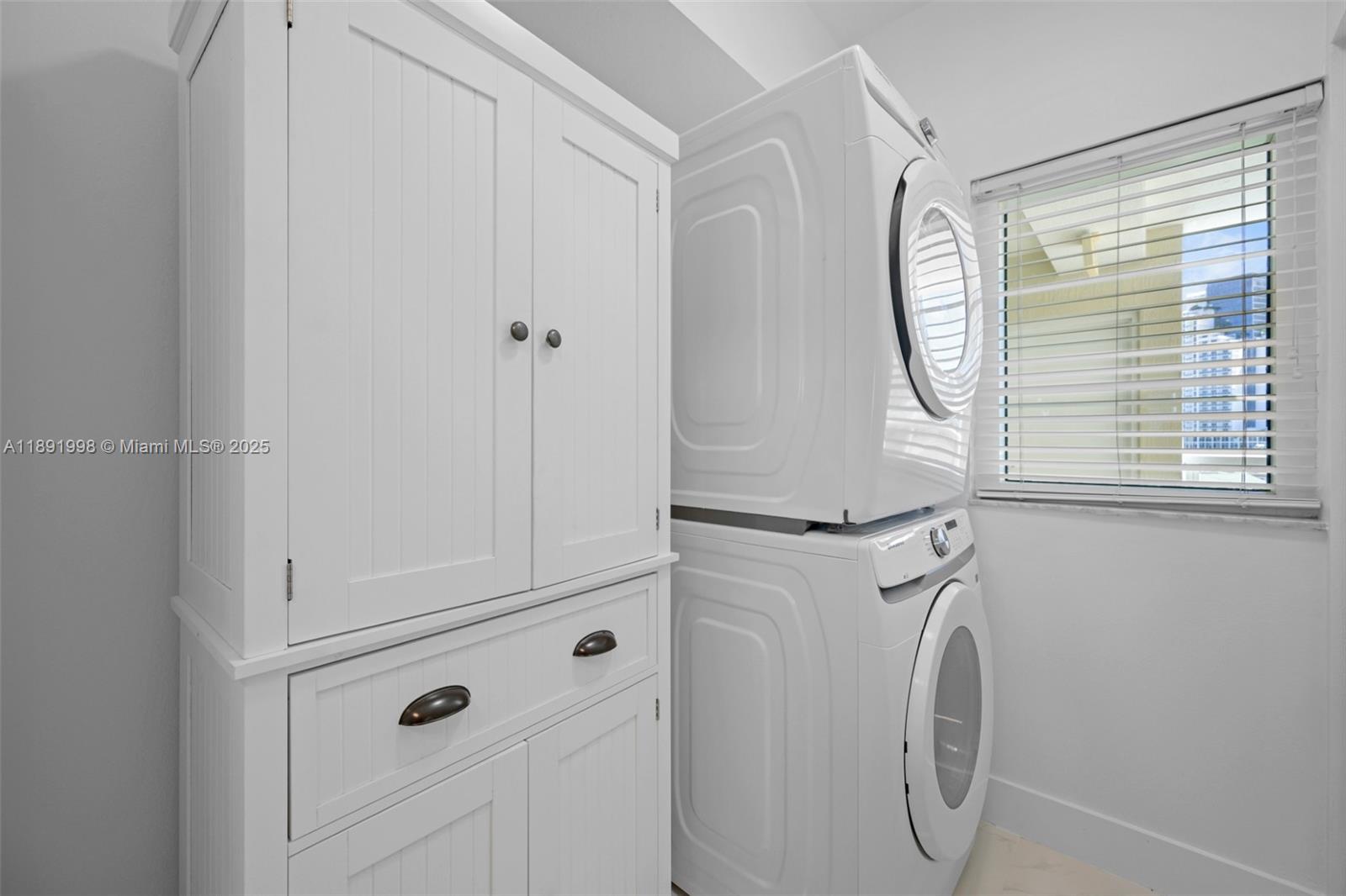 18100 North Bay Road, Unit 708 Sunny Isles Beach, FL 33160 - Photo 11 of 26 a close view of utility room with washer and dryer