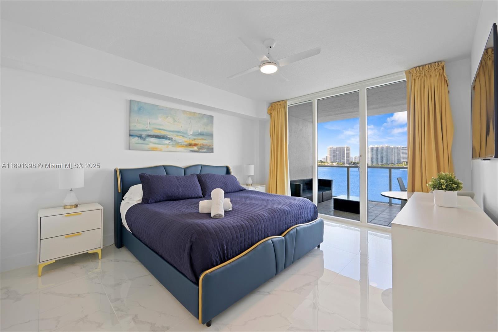 18100 North Bay Road, Unit 708 Sunny Isles Beach, FL 33160 - Photo 12 of 26 a bedroom with a bed and a couch
