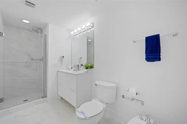a bathroom with a toilet a sink and shower