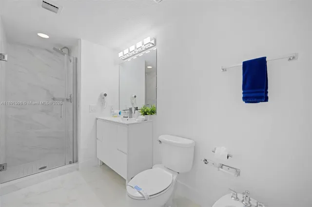 a bathroom with a toilet a sink and shower