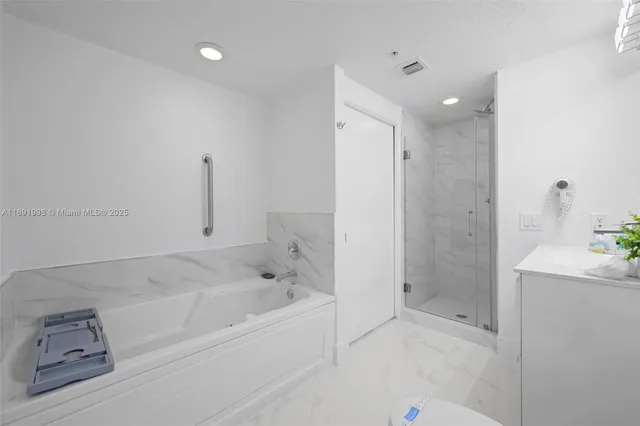 a bathroom with a bathtub and a shower