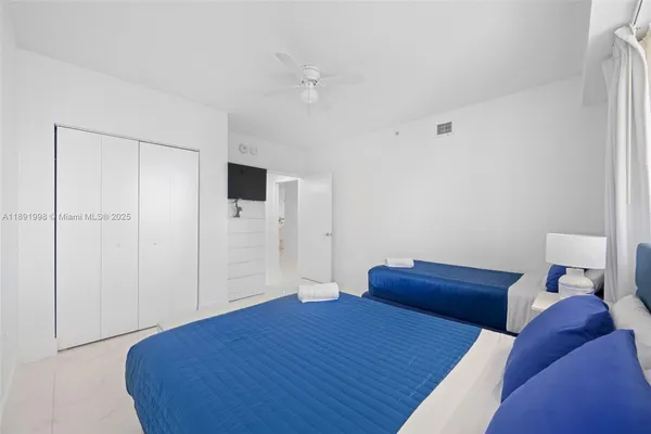 a bedroom with a bed and a tv