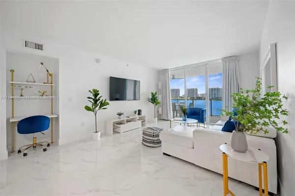 a living room with furniture and a potted plant