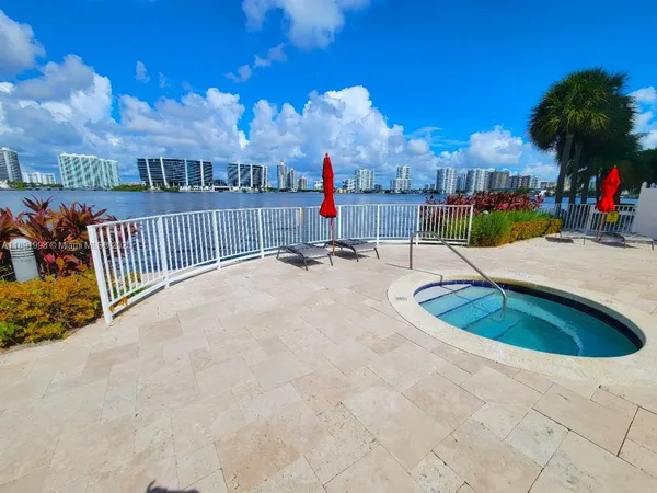 a view of a swimming pool with a patio and a yard
