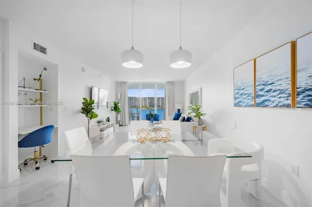 a view of a dining room with furniture and a potted plant