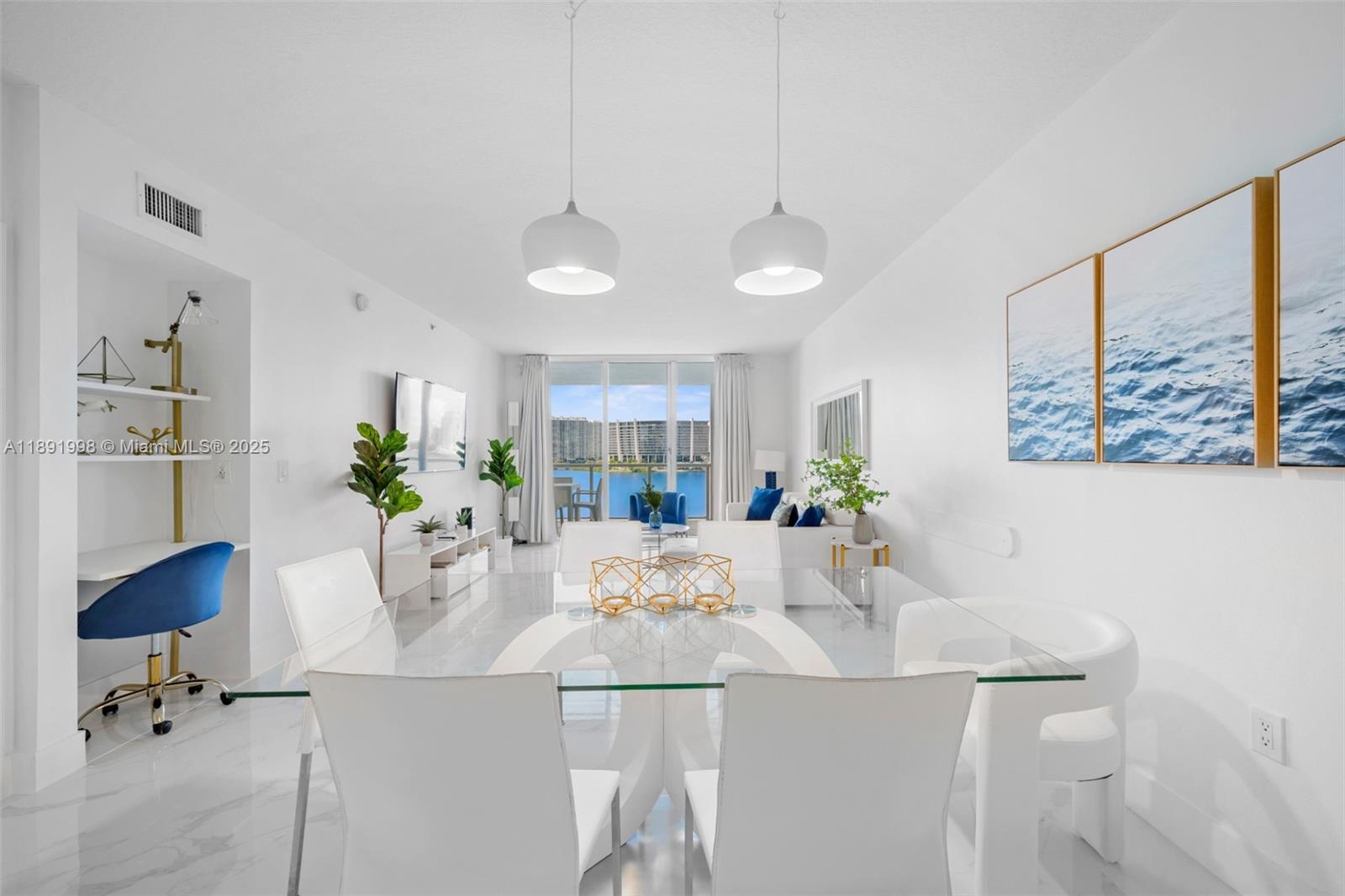 18100 North Bay Road, Unit 708 Sunny Isles Beach, FL 33160 - Photo 8 of 26 a view of a dining room with furniture and a potted plant