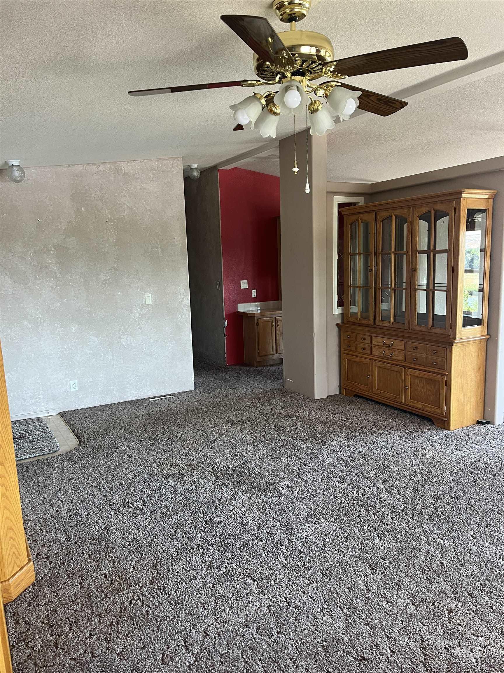 2750 Alden Road, Unit 34 Fruitland, ID 83619 - Photo 17 of 41 Unfurnished room with a textured ceiling, ceiling fan, and dark carpet