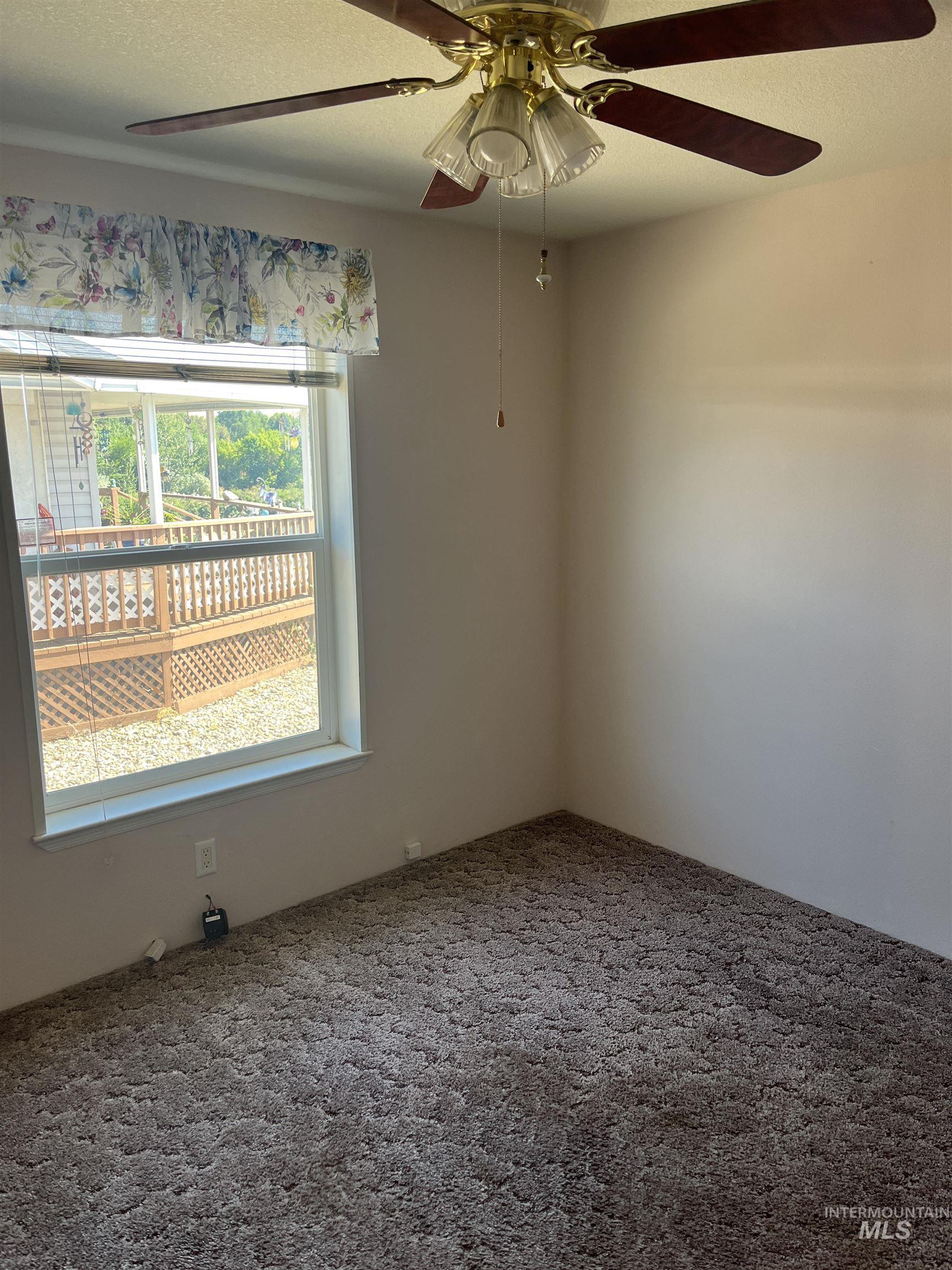 2750 Alden Road, Unit 34 Fruitland, ID 83619 - Photo 25 of 41 Empty room with a textured ceiling, carpet, and ceiling fan
