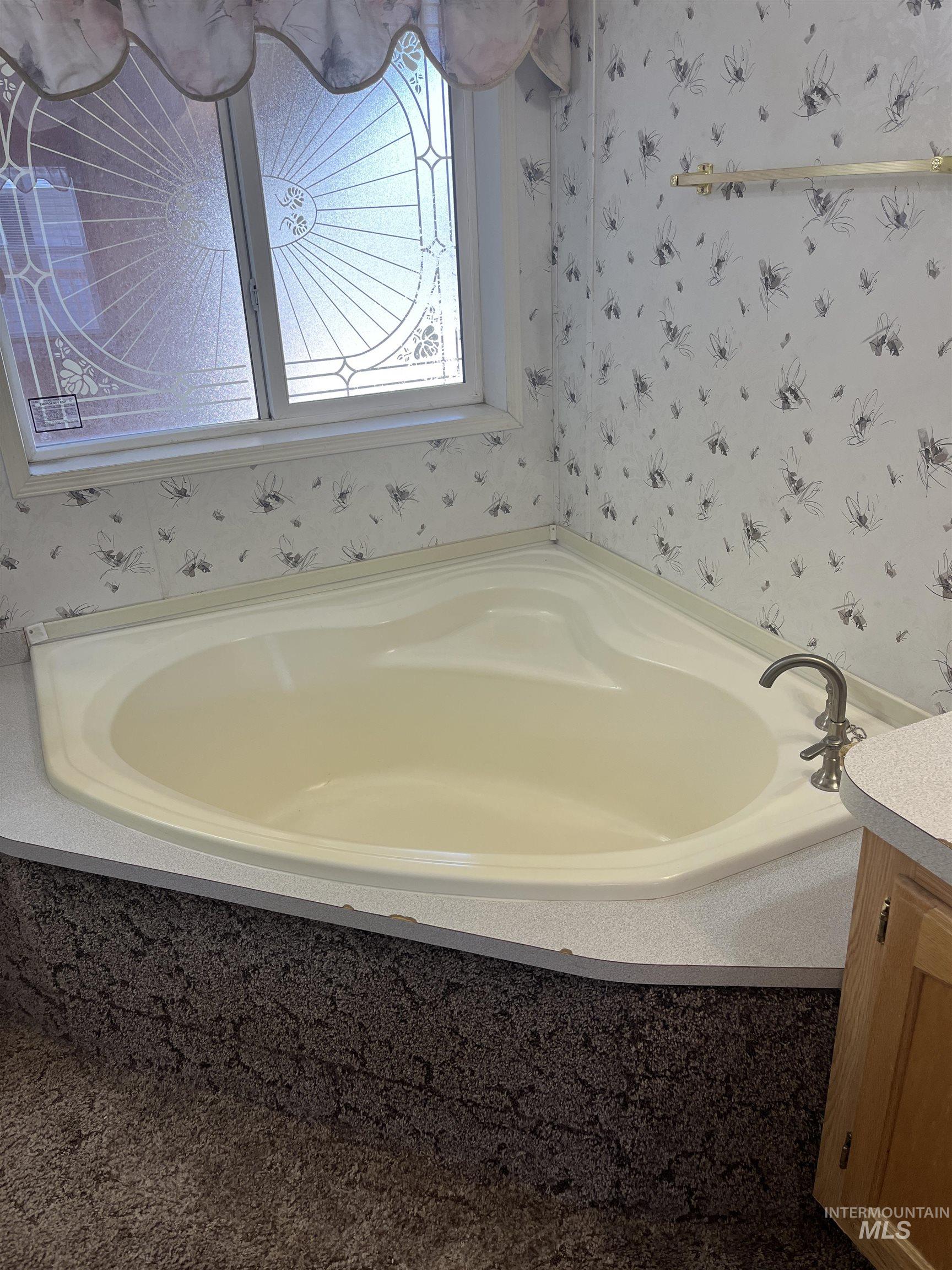 2750 Alden Road, Unit 34 Fruitland, ID 83619 - Photo 35 of 41 Bathroom featuring wallpapered walls, a garden tub, and vanity