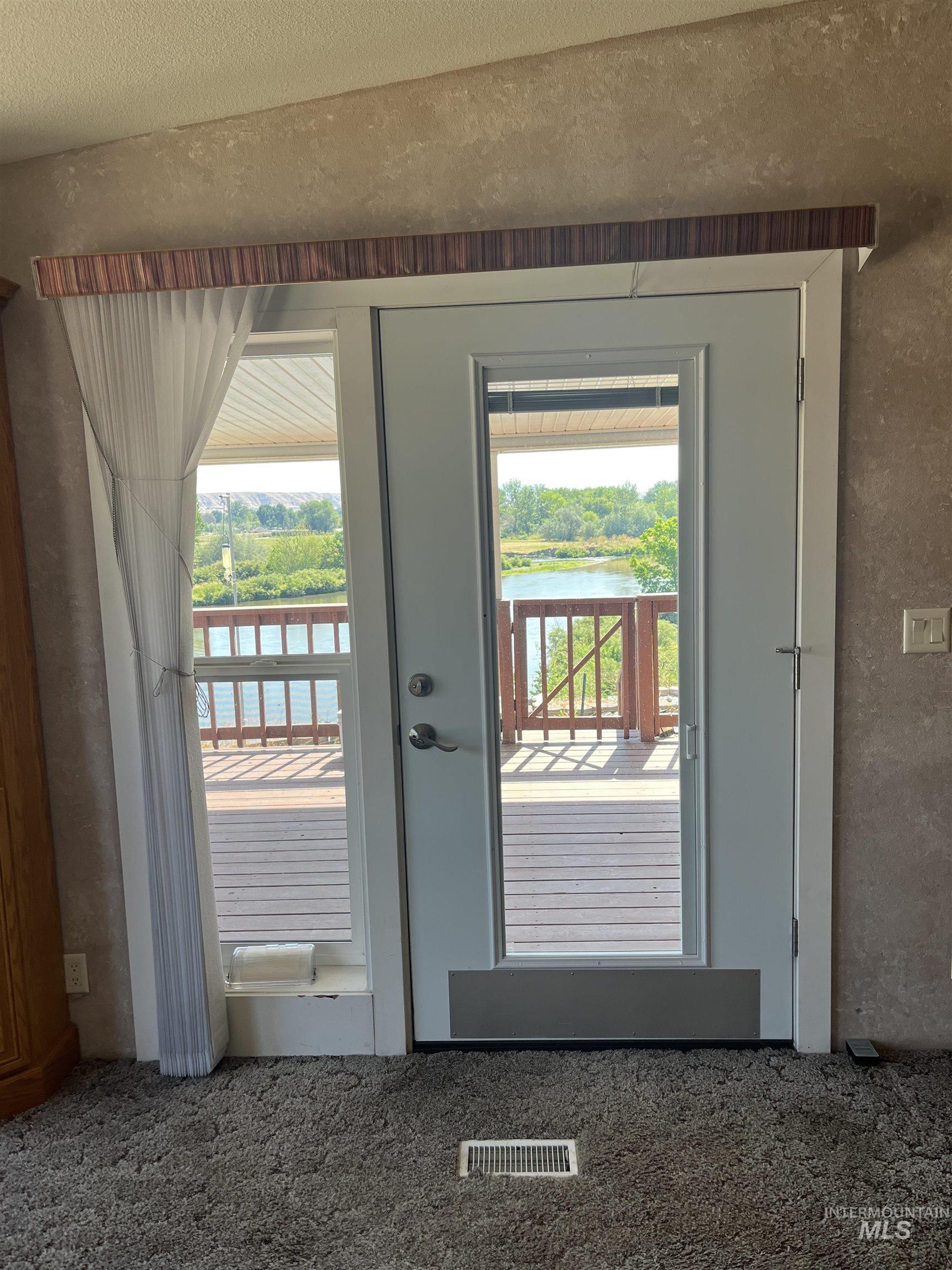 2750 Alden Road, Unit 34 Fruitland, ID 83619 - Photo 40 of 41 Entryway featuring a water view, carpet flooring, and a textured ceiling