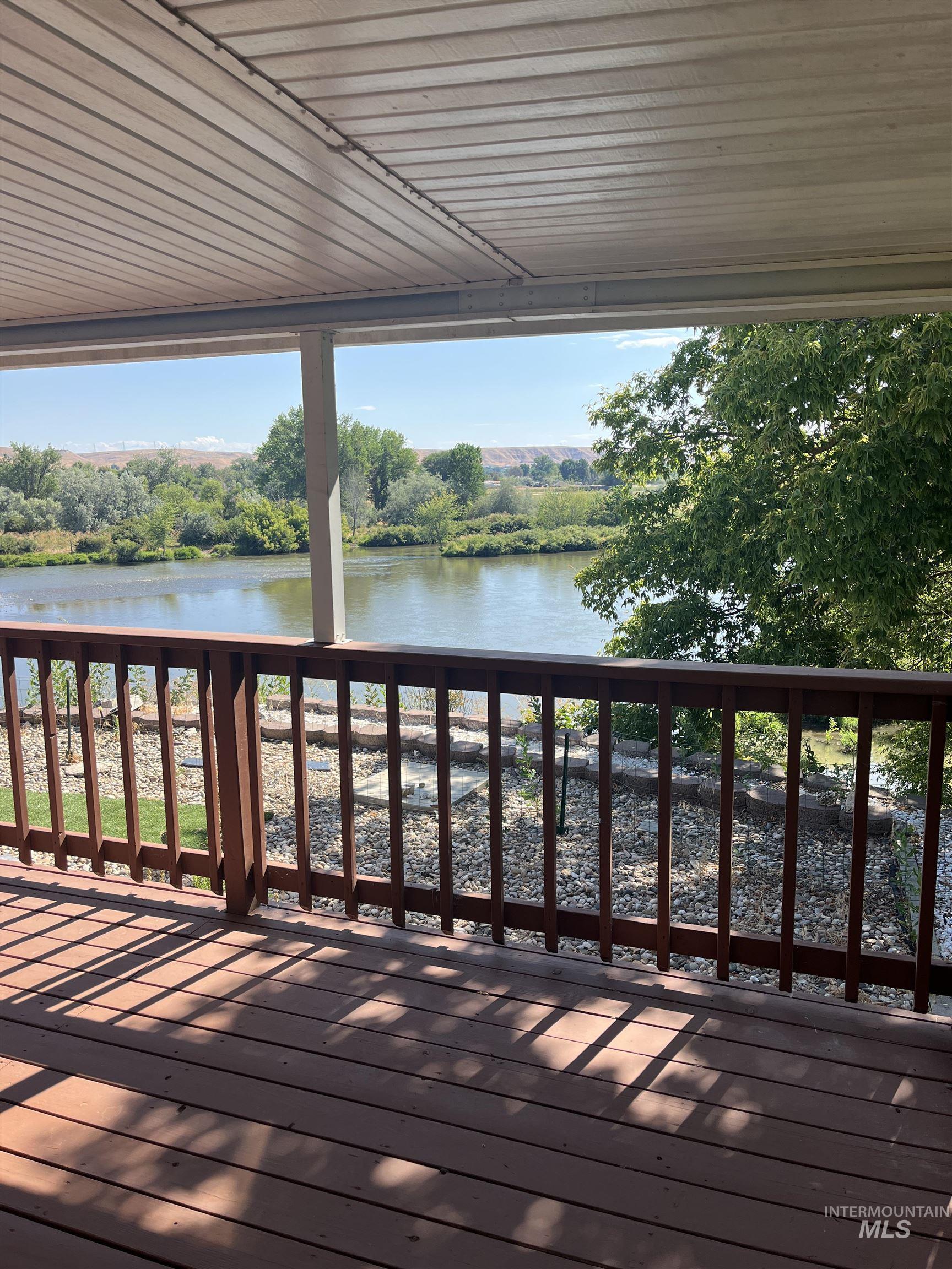 2750 Alden Road, Unit 34 Fruitland, ID 83619 - Photo 10 of 41 Deck featuring a water view and view of wooded area