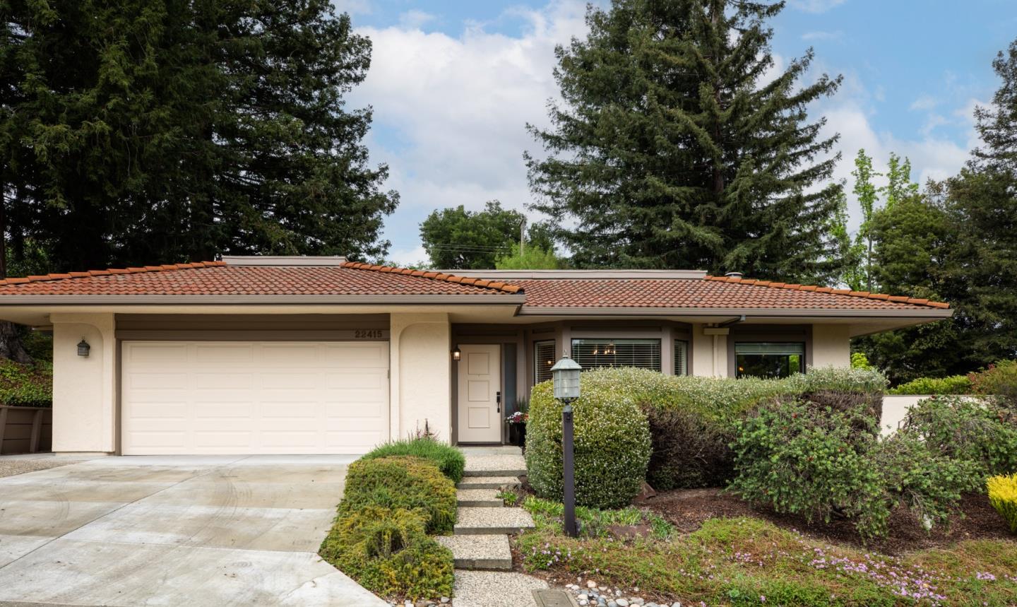 22415 Rancho Deep Cliff Drive Cupertino, CA 95014 - Photo 1 of 33 a front view of a house with garden