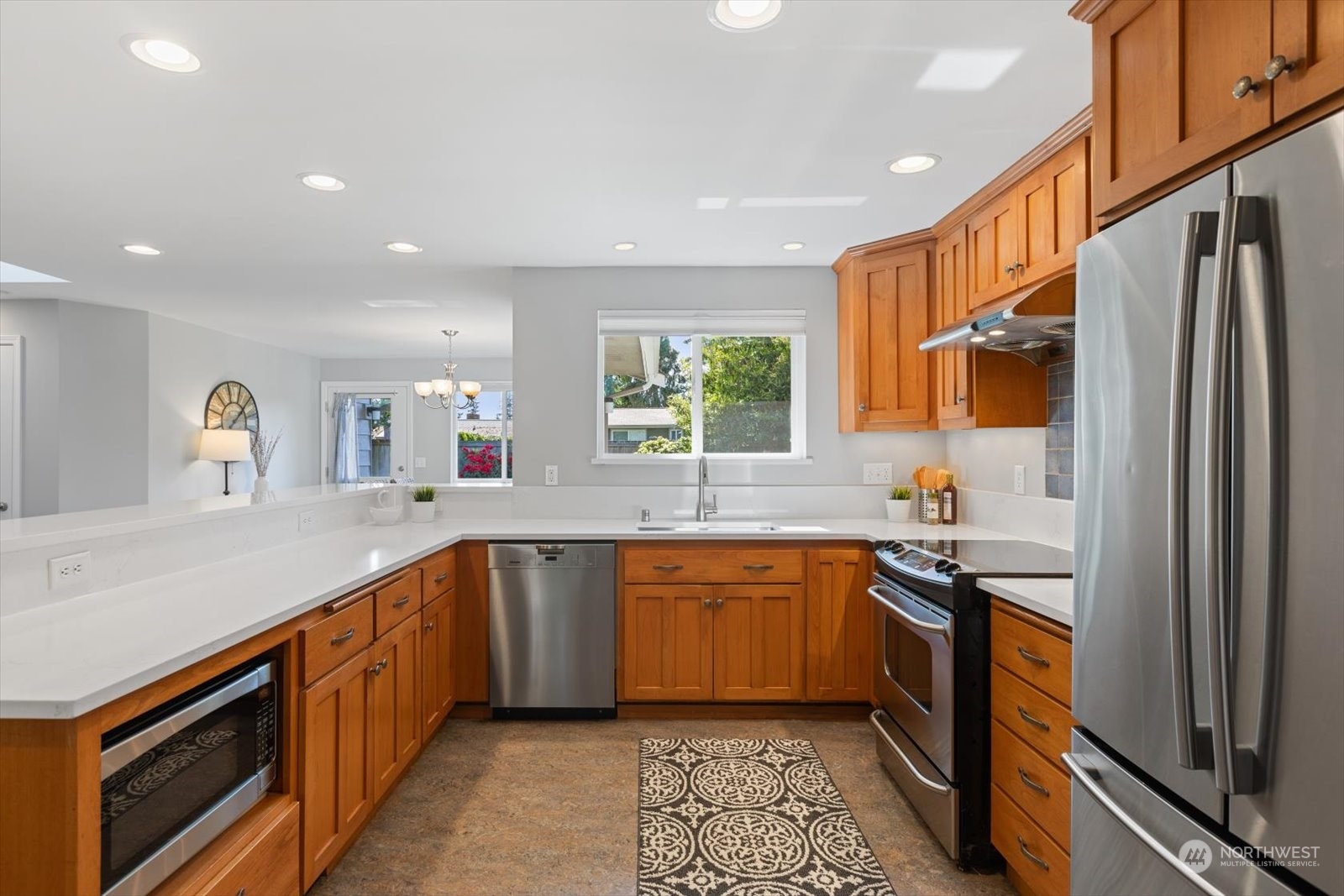 8630 217th Street Southwest Edmonds, WA 98026 - Photo 16 of 34 a kitchen with stainless steel appliances granite countertop sink stove refrigerator and cabinets
