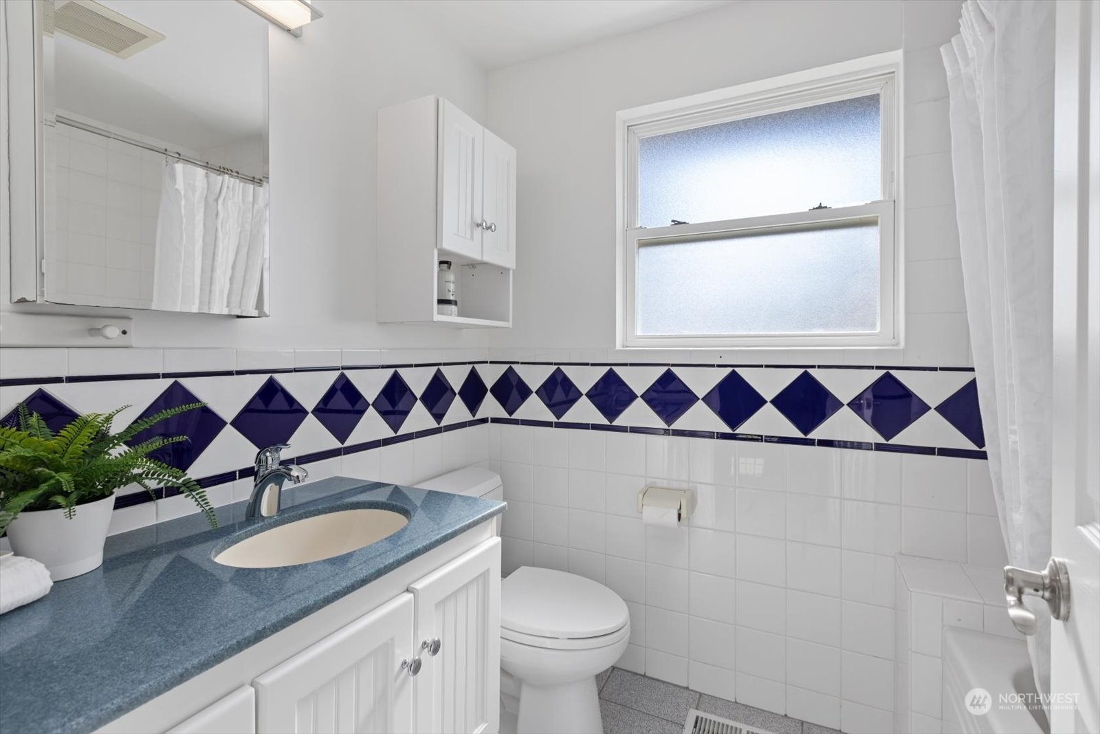 8630 217th Street Southwest Edmonds, WA 98026 - Photo 27 of 34 a bathroom with a granite countertop sink a toilet and a mirror