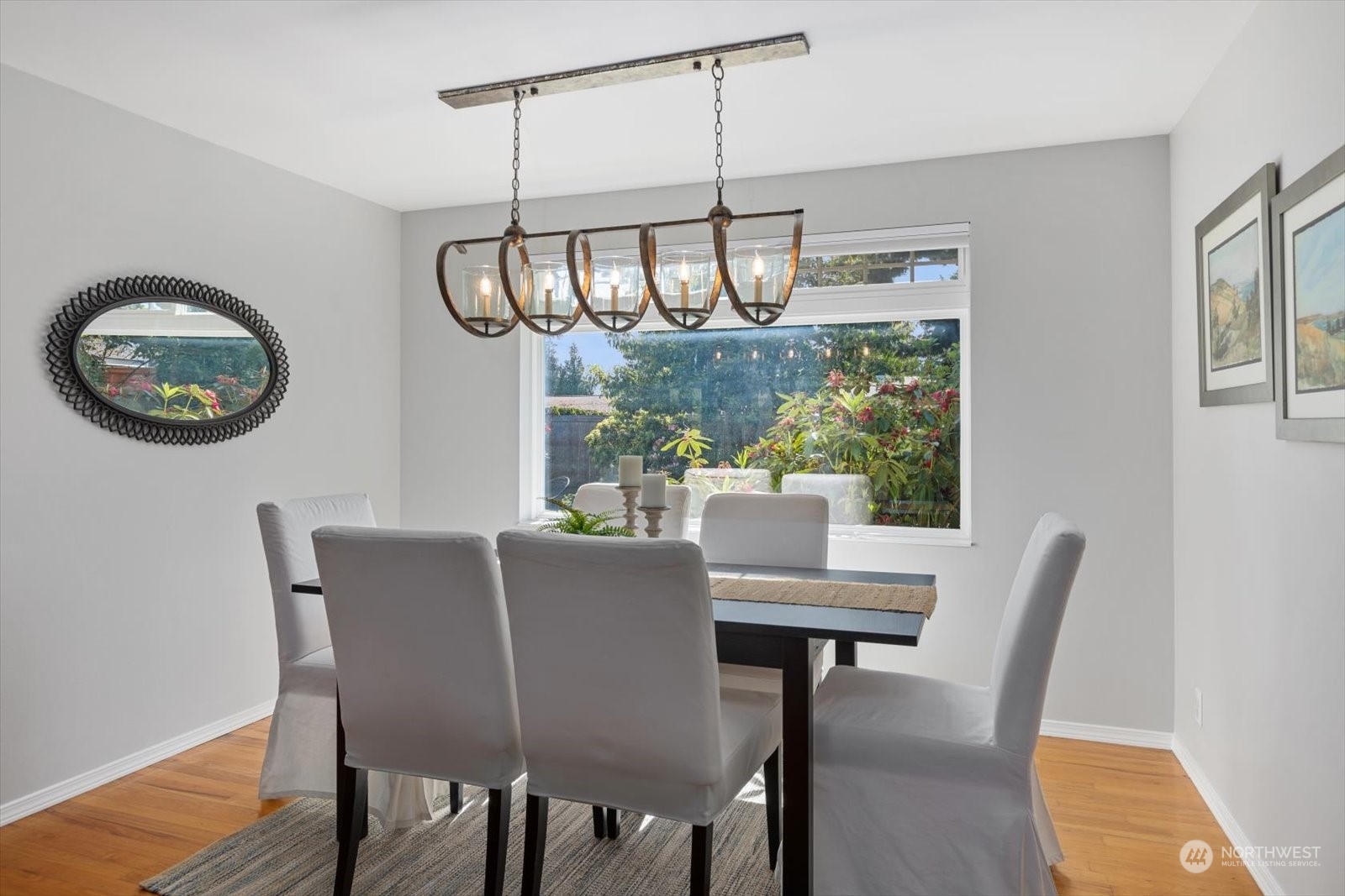 8630 217th Street Southwest Edmonds, WA 98026 - Photo 6 of 34 a view of a dining room with furniture window and wooden floor