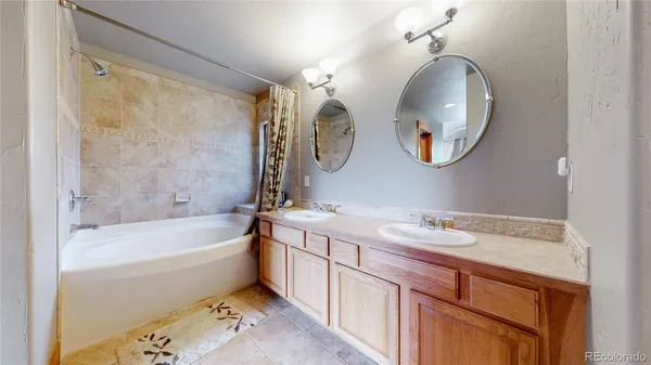 a bathroom with a bathtub a mirror and a sink