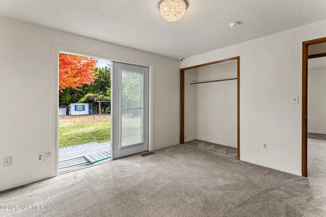 an empty room with an outdoor view and a window