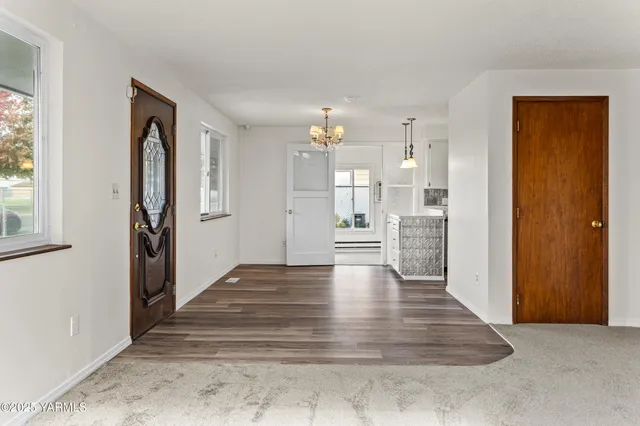 a view of kitchen with refrigerator and window