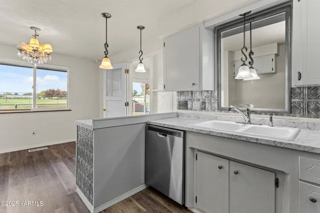 a bathroom with a granite countertop sink a large mirror and a window