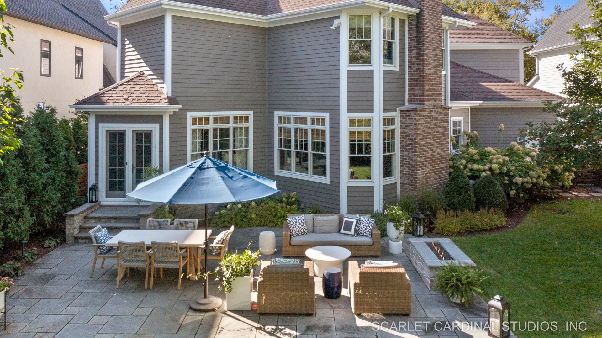 716 Wellner Road Naperville, IL 60540 - Photo 44 of 52 a view of a patio with table and chairs under an umbrella