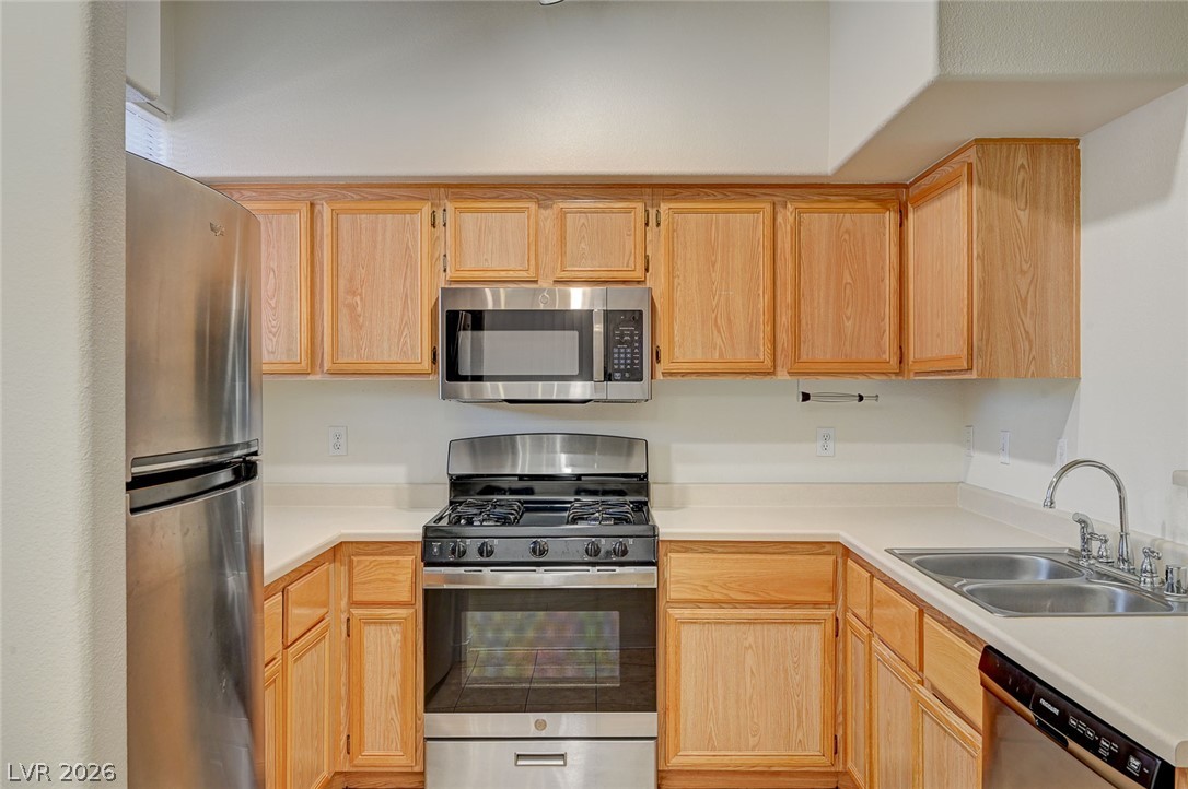 9050 West Warm Springs Road, Unit 1147 Las Vegas, NV 89148 - Photo 12 of 36 Natural wood cabinetry and stainless steel appliances complete this compact, efficient kitchen.