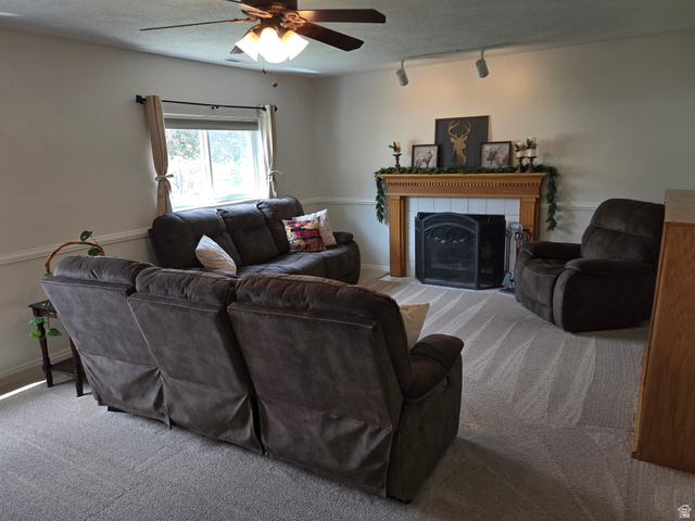 1263 Grayson Court Sandy, UT 84094 - Photo 16 of 26 Carpeted living area featuring a fireplace