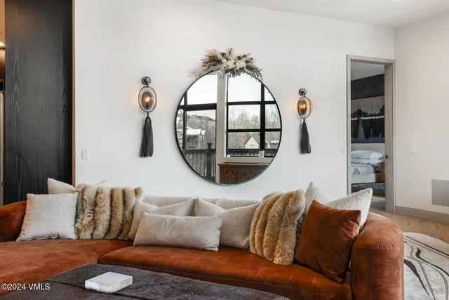 a bedroom with a bed couch and a window