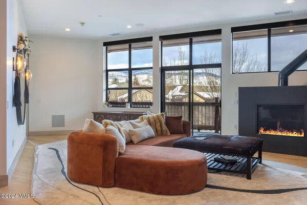 a living room with furniture and a floor to ceiling window