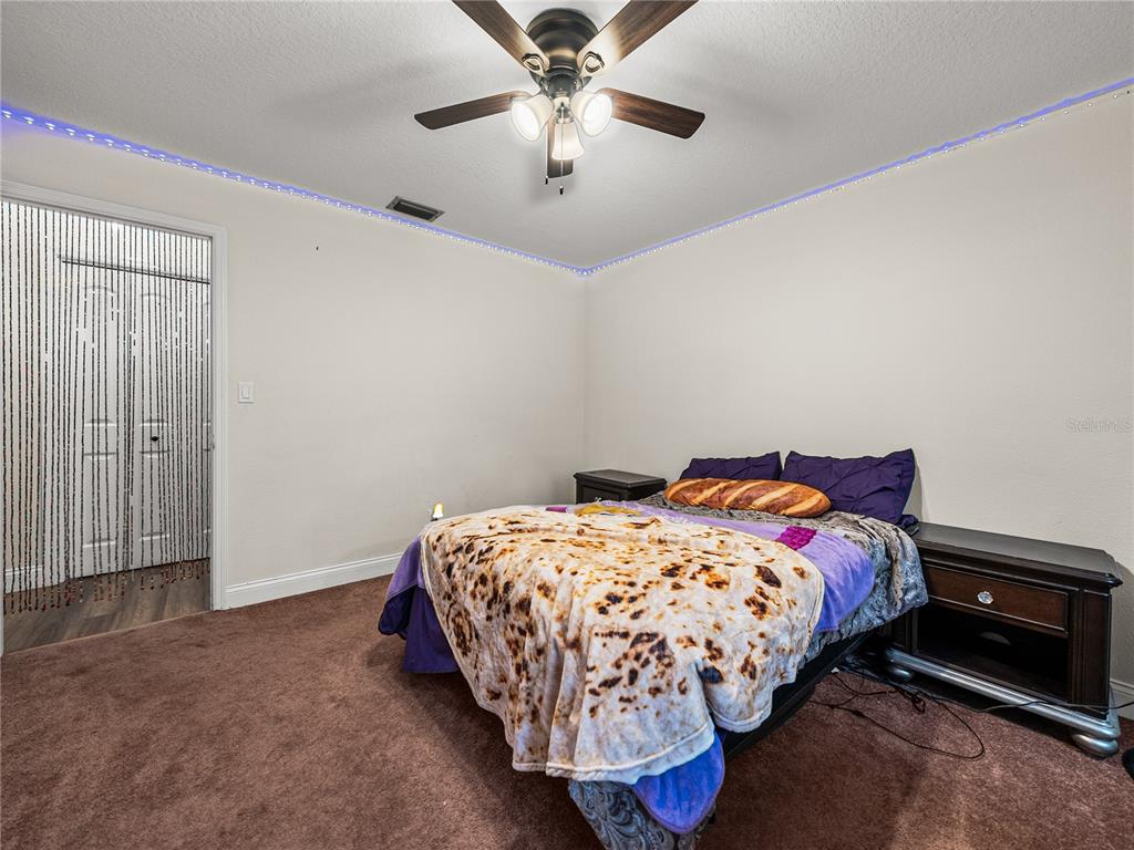 609 West Pipkin Road Lakeland, FL 33813 - Photo 31 of 72 a bedroom with a bed and a ceiling fan
