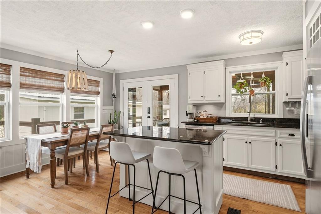 21 McIntosh Lane Rabun Gap, GA 30568 - Photo 11 of 50 a kitchen with granite countertop lots of white cabinets and stainless steel appliances