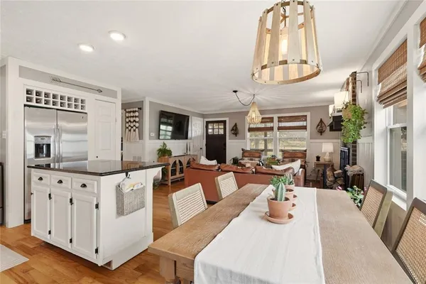 a living room with furniture a fireplace and a chandelier