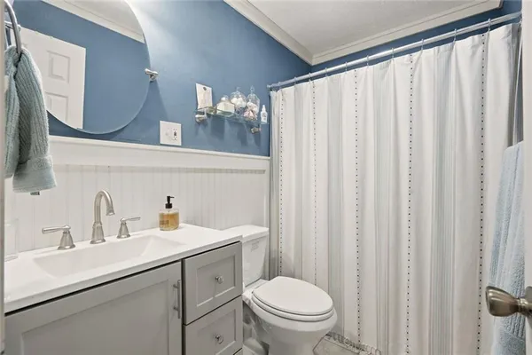 a bathroom with a sink a toilet and mirror