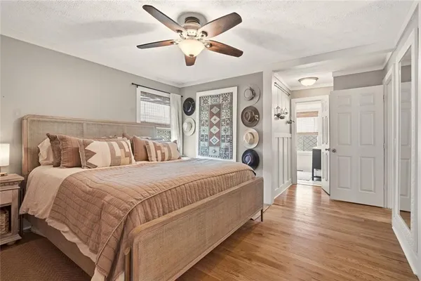 a spacious bedroom with a large bed and a chandelier