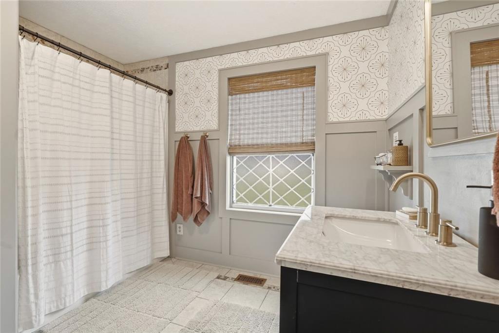 21 McIntosh Lane Rabun Gap, GA 30568 - Photo 26 of 53 a bathroom with a granite countertop sink and a window