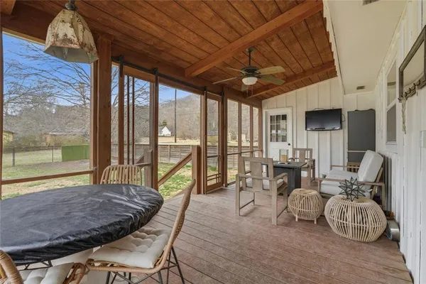 a living room with furniture and a floor to ceiling window