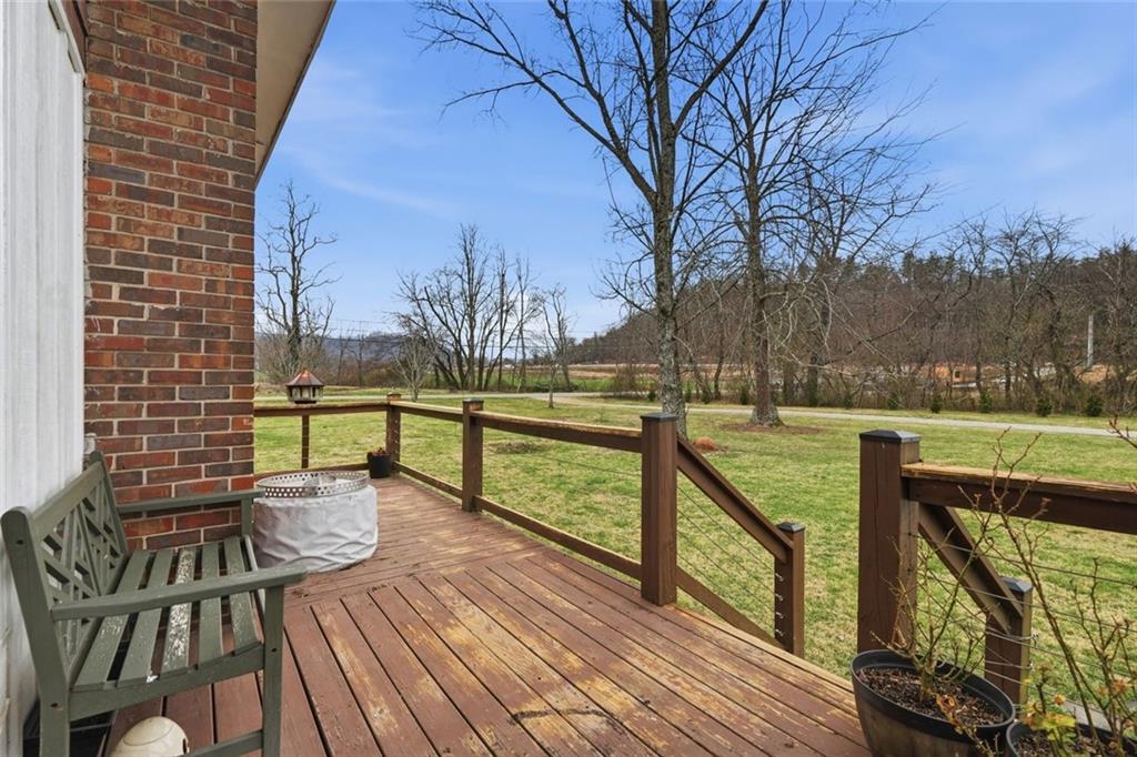 21 McIntosh Lane Rabun Gap, GA 30568 - Photo 37 of 53 a view of a deck with a table and chairs next to a yard