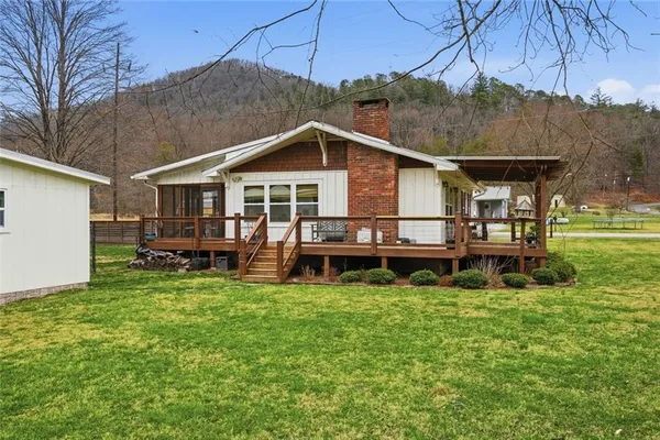 a view of a house with a yard porch and sitting area