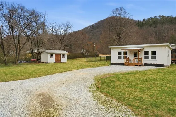 a view of house with outdoor space and swimming pool