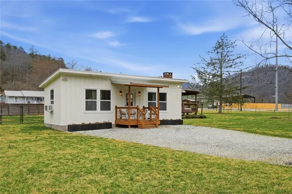 a view of a house with backyard sitting area and garden