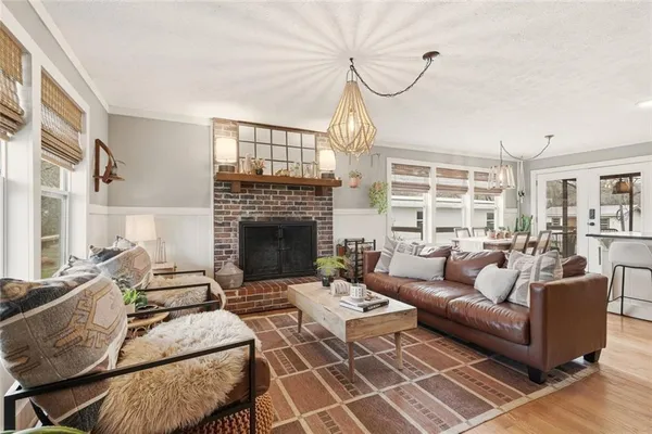 a living room with furniture a rug and a fireplace