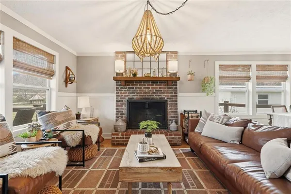 a living room with furniture a rug and a fireplace