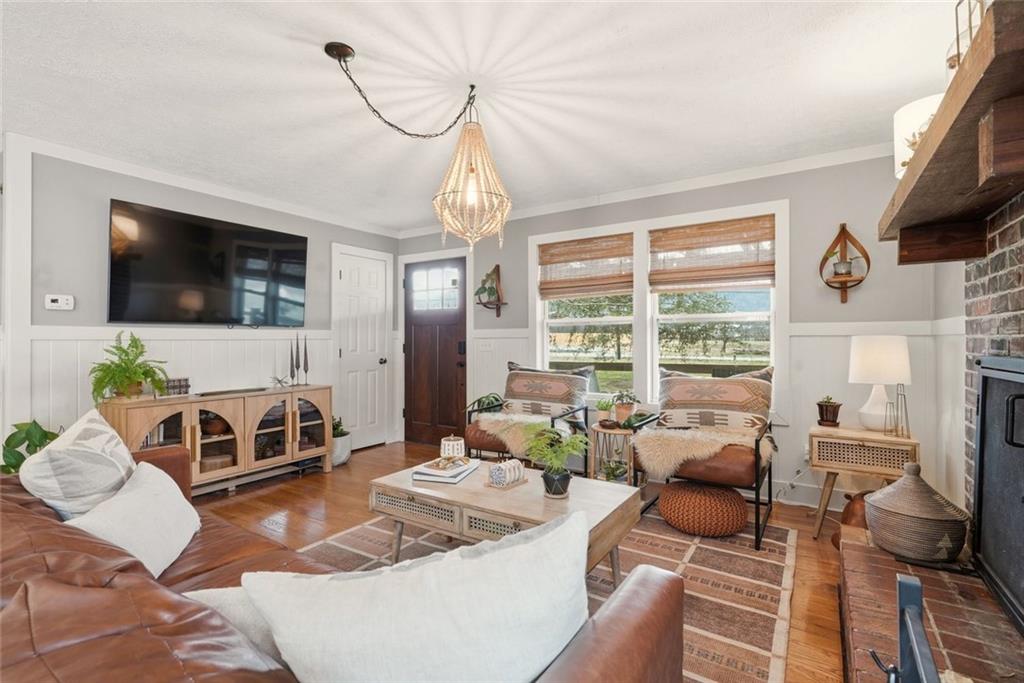 21 McIntosh Lane Rabun Gap, GA 30568 - Photo 8 of 50 a living room with furniture a flat screen tv and a large window