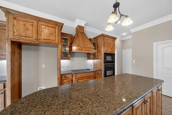 a kitchen with stainless steel appliances granite countertop a sink refrigerator and cabinets