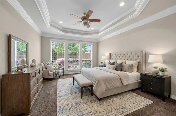 a bedroom with a large bed and a couch