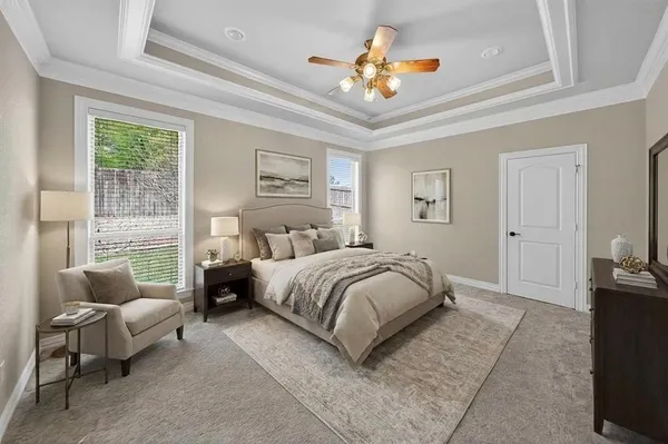 a bedroom with a bed couch and window