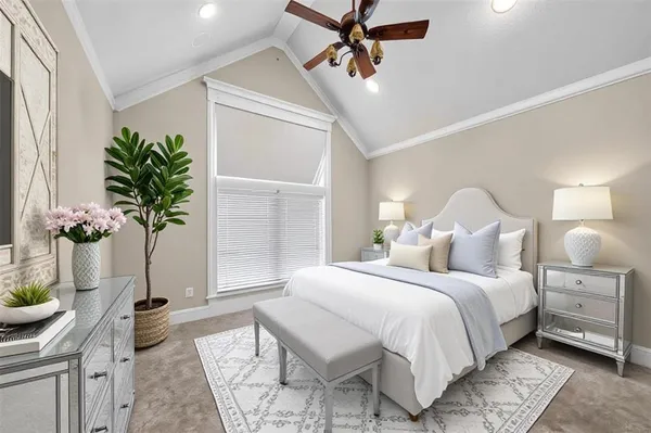 a bedroom with a bed and a potted plant