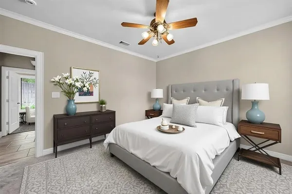 a bedroom with a bed and a chandelier