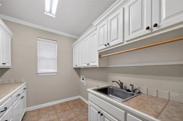 a kitchen with white cabinets and a sink