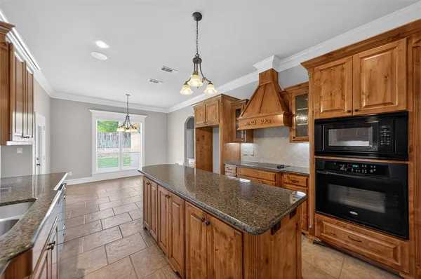 a kitchen with stainless steel appliances granite countertop a sink a microwave counter space and cabinets